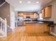 Bright kitchen features wood cabinets, stainless steel appliances, and convenient access to stairs and side door at 7536 Shasta Dr, Indianapolis, IN 46217