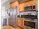 Spacious kitchen showcases stainless steel refrigerator and oven, and light wood cabinets at 7536 Shasta Dr, Indianapolis, IN 46217