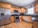 Well-equipped kitchen with stainless appliances, wooden cabinets, and modern fixtures for culinary enthusiasts at 7536 Shasta Dr, Indianapolis, IN 46217
