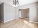 Well-lit living room with hardwood flooring, a classic chandelier, and neutral wall color at 7536 Shasta Dr, Indianapolis, IN 46217