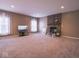 Large living room featuring cozy fireplace, neutral carpet, and ample room for furniture arrangement at 7536 Shasta Dr, Indianapolis, IN 46217