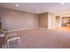 Bright living room with recessed lighting and smooth carpet transitioning to hardwood floors with open floor plan at 7536 Shasta Dr, Indianapolis, IN 46217
