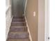 Carpeted staircase with white railing offers access to upper level at 7536 Shasta Dr, Indianapolis, IN 46217
