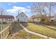 A spacious backyard featuring a well-maintained lawn and a charming gray house in a cozy neighborhood at 766 N Bancroft St, Indianapolis, IN 46201