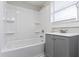 Bathroom with tub/shower combination and gray vanity at 766 N Bancroft St, Indianapolis, IN 46201