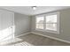 Cozy bedroom featuring natural light from two windows and neutral carpeting at 766 N Bancroft St, Indianapolis, IN 46201