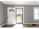 Bright entryway featuring an open door with security screen and natural light, hardwood floors at 766 N Bancroft St, Indianapolis, IN 46201