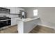 Modern kitchen with stainless steel appliances, granite countertops, and an island at 766 N Bancroft St, Indianapolis, IN 46201