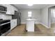 Modern kitchen featuring stainless steel appliances, granite countertops, and white cabinets at 766 N Bancroft St, Indianapolis, IN 46201
