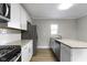 Well-lit kitchen featuring granite countertops, stainless steel appliances, and hardwood flooring at 766 N Bancroft St, Indianapolis, IN 46201