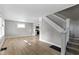 Bright living room featuring light hardwood floors, fresh paint and a view of the stairway at 766 N Bancroft St, Indianapolis, IN 46201