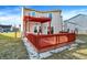 Comfortable wooden back deck with bright orange pergola, perfect for entertaining outdoors at 7939 Crackling Ln, Indianapolis, IN 46259