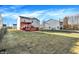 Fenced backyard with well-maintained lawn and wooden deck featuring a bright orange pergola at 7939 Crackling Ln, Indianapolis, IN 46259