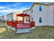 This home features a spacious backyard and a red wooden deck with pergola, perfect for entertaining at 7939 Crackling Ln, Indianapolis, IN 46259
