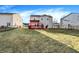 Wide, fenced backyard featuring a red wooden deck with a bright orange pergola over top at 7939 Crackling Ln, Indianapolis, IN 46259