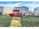 Picture of the house's spacious backyard and cozy wooden deck with a bright orange pergola at 7939 Crackling Ln, Indianapolis, IN 46259