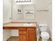 Well-lit bathroom with a single sink vanity, toilet, and accessible features at 7939 Crackling Ln, Indianapolis, IN 46259