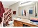 Well-lit bathroom with functional vanity, large mirror, and shower-tub combination, blending form and function at 7939 Crackling Ln, Indianapolis, IN 46259