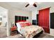 Light-filled bedroom with a ceiling fan, bedside table, and seamless access to other areas of the house at 7939 Crackling Ln, Indianapolis, IN 46259
