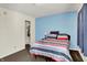 Cozy bedroom with a large closet space and a vibrant accent wall in a soothing blue hue at 7939 Crackling Ln, Indianapolis, IN 46259