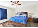 This bedroom showcases a dark wood bed frame, a ceiling fan, and carpeted flooring at 7939 Crackling Ln, Indianapolis, IN 46259