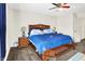 Bedroom features neutral walls, carpet, and a bed with blue bedding for a cozy feel at 7939 Crackling Ln, Indianapolis, IN 46259