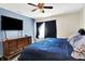 Bedroom with a TV, dresser, and bed with blue bedding against a two-toned wall at 7939 Crackling Ln, Indianapolis, IN 46259