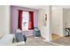 Office space with a desk, a window with red curtains, and access to the entryway at 7939 Crackling Ln, Indianapolis, IN 46259