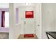 Bright entryway with a white front door, neutral tile flooring, and adjacent purple walls at 7939 Crackling Ln, Indianapolis, IN 46259