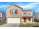 Charming two-story home features a brick facade, red shutters, and a two-car garage at 7939 Crackling Ln, Indianapolis, IN 46259