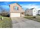 Well-maintained two-story home with a brick front, attached garage and large driveway at 7939 Crackling Ln, Indianapolis, IN 46259