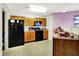 Functional kitchen with black appliances and warm wood cabinets at 7939 Crackling Ln, Indianapolis, IN 46259