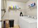Efficient laundry room equipped with modern washer and dryer, shelving, and organized storage solutions at 7939 Crackling Ln, Indianapolis, IN 46259