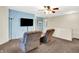 Comfortable living room with plush seating, large television and a ceiling fan for comfortable living at 7939 Crackling Ln, Indianapolis, IN 46259