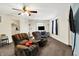 The open living room features plush seating, television and multiple windows for natural light at 7939 Crackling Ln, Indianapolis, IN 46259