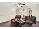 The open living room area includes plush seating and a ceiling fan for comfortable living at 7939 Crackling Ln, Indianapolis, IN 46259