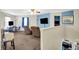 Open living room with plush seating, desk area and a large television for relaxing or entertaining guests at 7939 Crackling Ln, Indianapolis, IN 46259