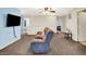 The upstairs living room features plush seating and a large television for relaxing or entertaining at 7939 Crackling Ln, Indianapolis, IN 46259