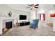 Inviting living room with a fireplace, neutral carpet, and a ceiling fan for added comfort at 7939 Crackling Ln, Indianapolis, IN 46259