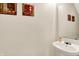 This powder room features a pedestal sink with a framed mirror and tasteful artwork at 7939 Crackling Ln, Indianapolis, IN 46259