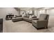 Basement living room with an L-shaped sofa, chair, and soft carpet, offering a cozy and inviting space at 804 Whispering Oaks Dr, Carmel, IN 46032