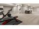 Finished basement gym with workout equipment and table with chairs, providing a functional and versatile space at 804 Whispering Oaks Dr, Carmel, IN 46032
