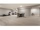 Wide angle shot of a finished basement featuring workout equipment, a table and chairs, and soft carpet at 804 Whispering Oaks Dr, Carmel, IN 46032