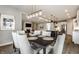 Dining room with views to the kitchen, living room, and fireplace, featuring modern decor at 804 Whispering Oaks Dr, Carmel, IN 46032