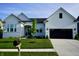 Charming two-story home featuring a manicured lawn, black garage door, and modern architectural details at 804 Whispering Oaks Dr, Carmel, IN 46032