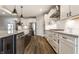 Kitchen featuring an island, stainless steel appliances, white cabinets, and light wood floors at 804 Whispering Oaks Dr, Carmel, IN 46032