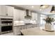 Contemporary kitchen with stainless steel appliances, white cabinets, and a spacious island at 804 Whispering Oaks Dr, Carmel, IN 46032