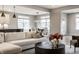 Bright and airy open floor plan with modern sofa, leading to the dining and kitchen areas at 804 Whispering Oaks Dr, Carmel, IN 46032