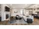 Inviting living room with fireplace, leading to the kitchen and featuring modern décor at 804 Whispering Oaks Dr, Carmel, IN 46032