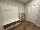 Bright mudroom with built in hall tree, storage baskets and a door at 804 Whispering Oaks Dr, Carmel, IN 46032